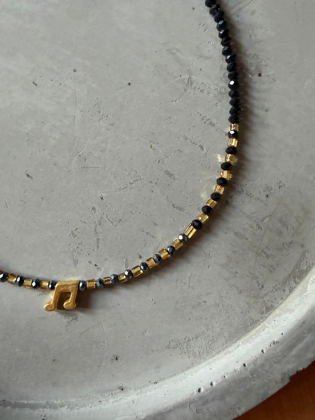 Necklace with music note pendant