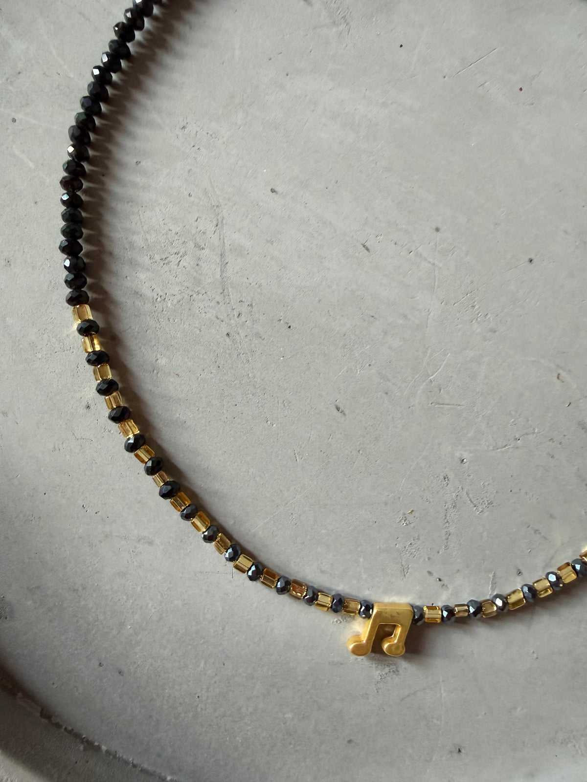 Necklace with music note pendant