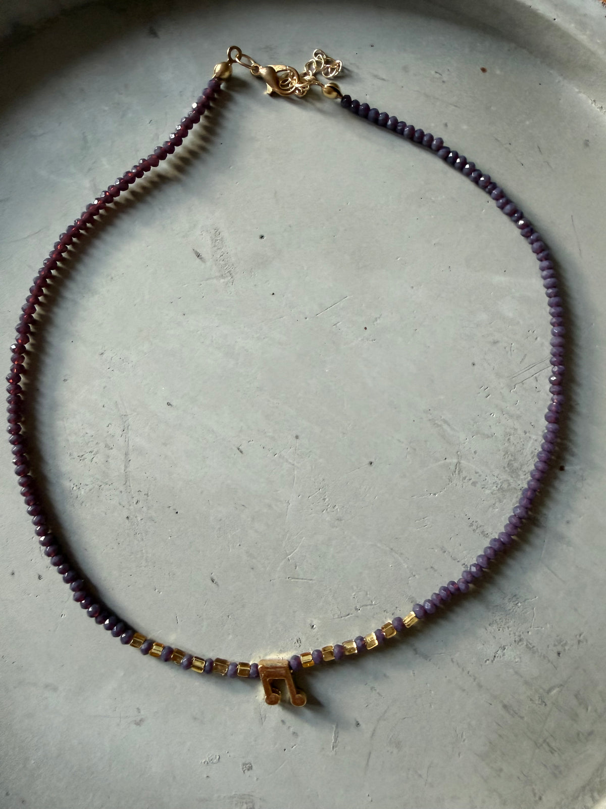 Necklace with music note pendant