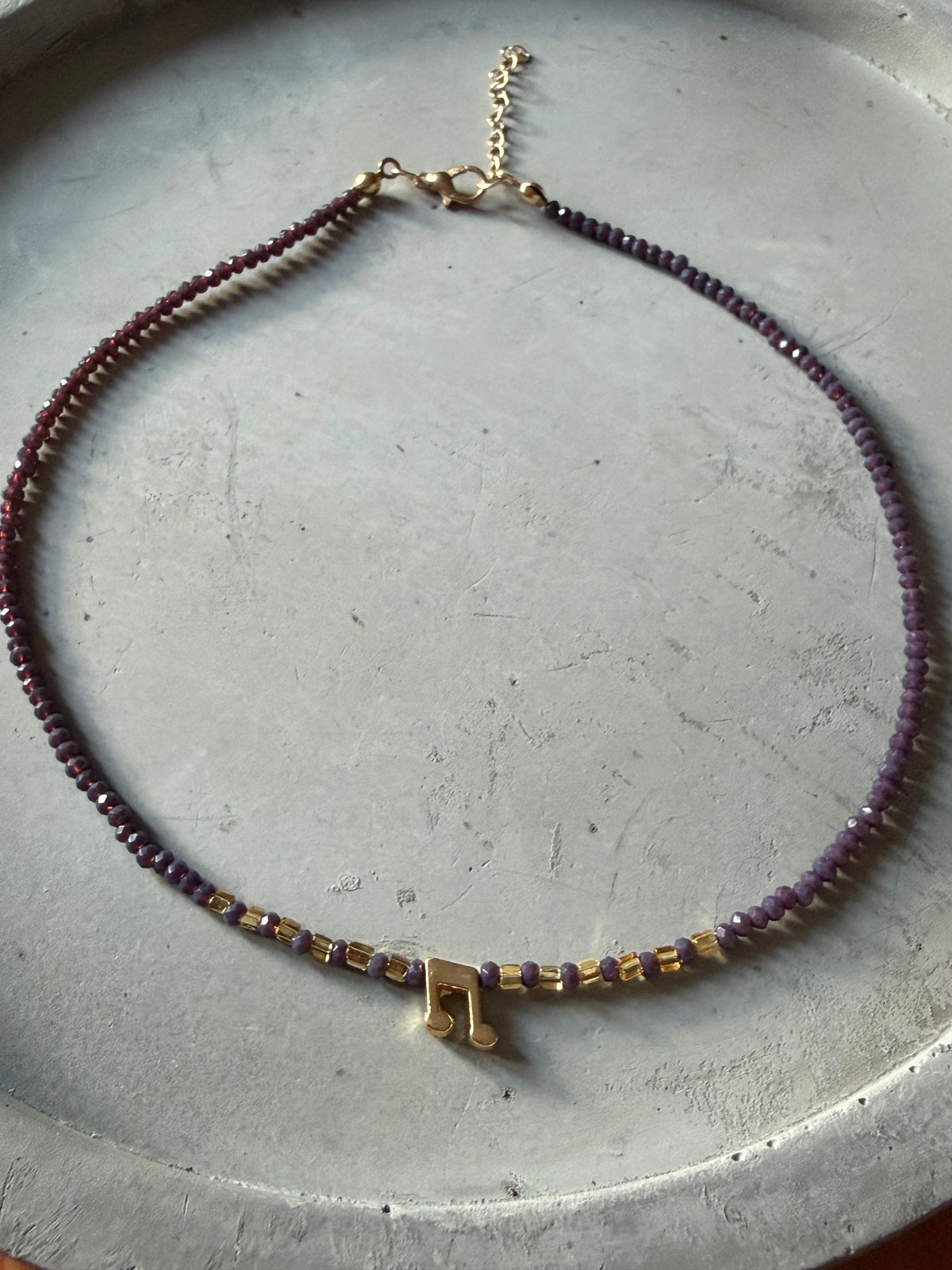 Necklace with music note pendant
