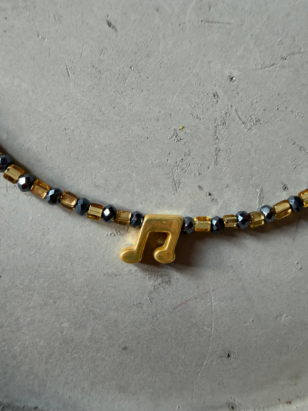 Necklace with music note pendant